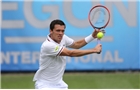 EASTBOURNE, ENGLAND - JUNE 16: Tobias Kamke of Germany plays a backhand against Daniel Evans of Great Britain during their Men's Singles first round match on day three of the Aegon International at Devonshire Park on June 16, 2014 in Eastbourne, England.  (Photo by Steve Bardens/Getty Images)